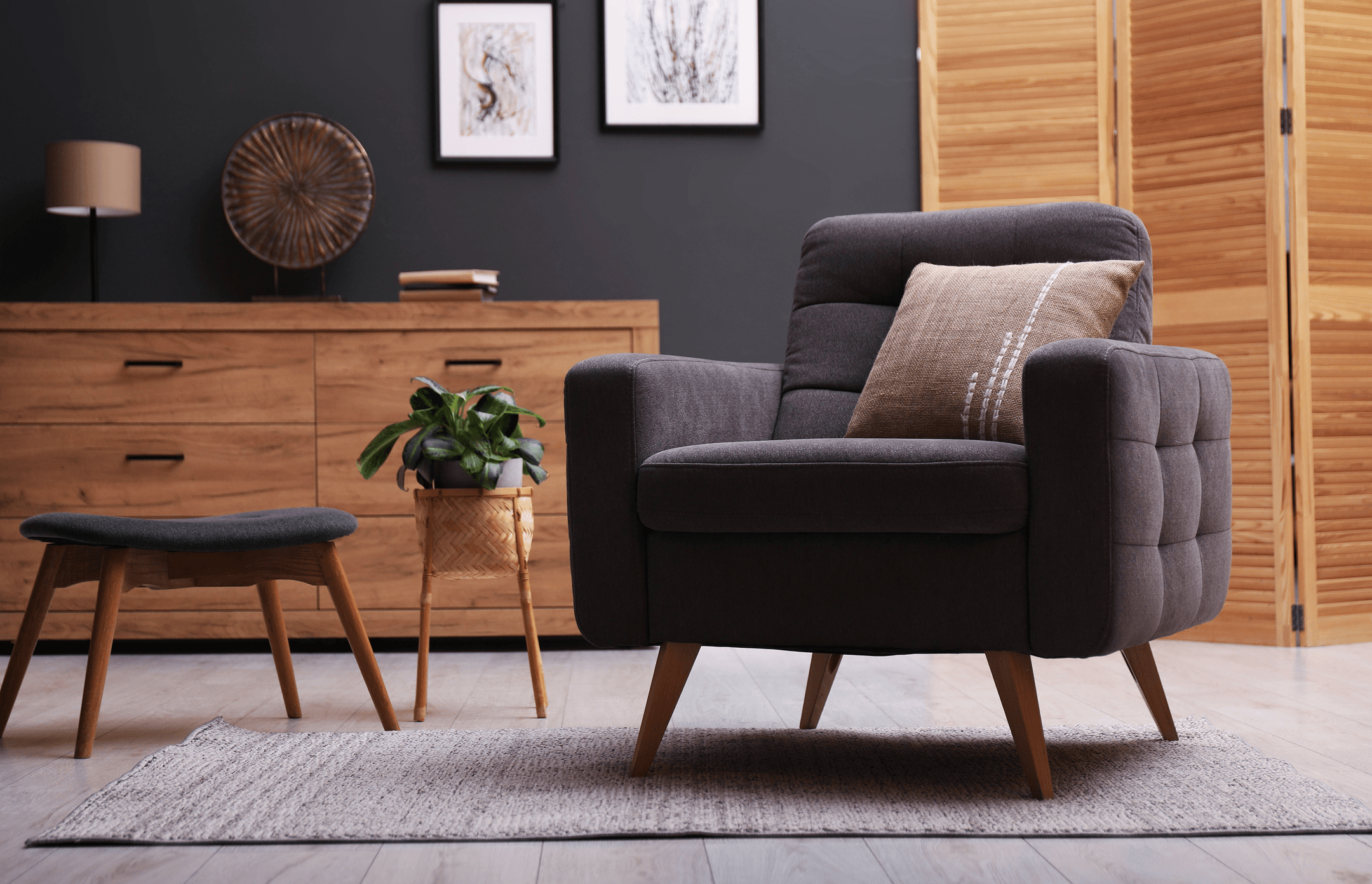 Upholstered armchair and stool in a styled living space